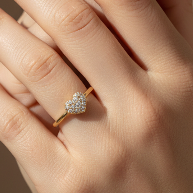 Anillo con corazón de diamantes en mano