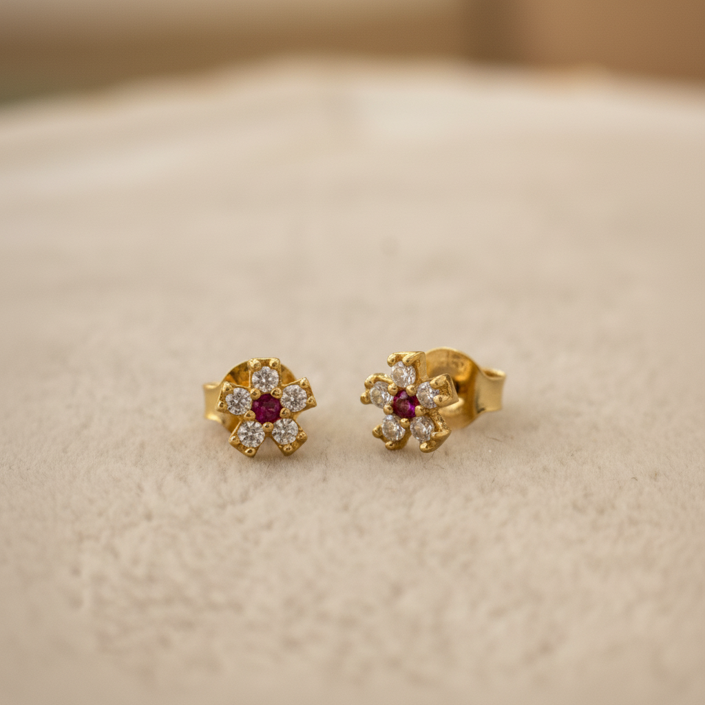 Aretes con rubí oro resaltado fondo limpio