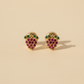 Aretes fresa oro 18k ambos de frente fondo beige luz natural