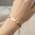Pulsera Tejida Placas on hand with pastel pink nails - different angle
