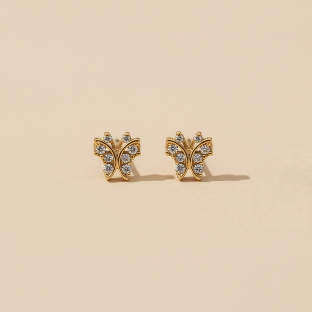 Topitos mariposa en oro con circones de frente